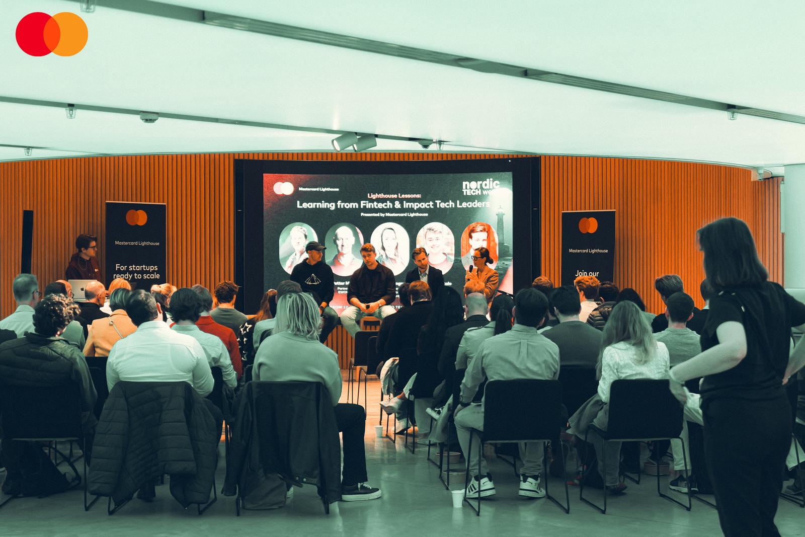 Four panellists onstage before a full room at the Mastercard Lighthouse session on fintech and impact tech during Nordic Tech Week in Stockholm