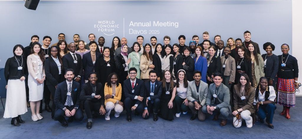 Delegates posed in two rows in front of the World Economic Forum Annual Meeting 2025 signage wall in Davos